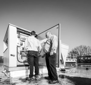 Two technicians looking at a piece of equipment